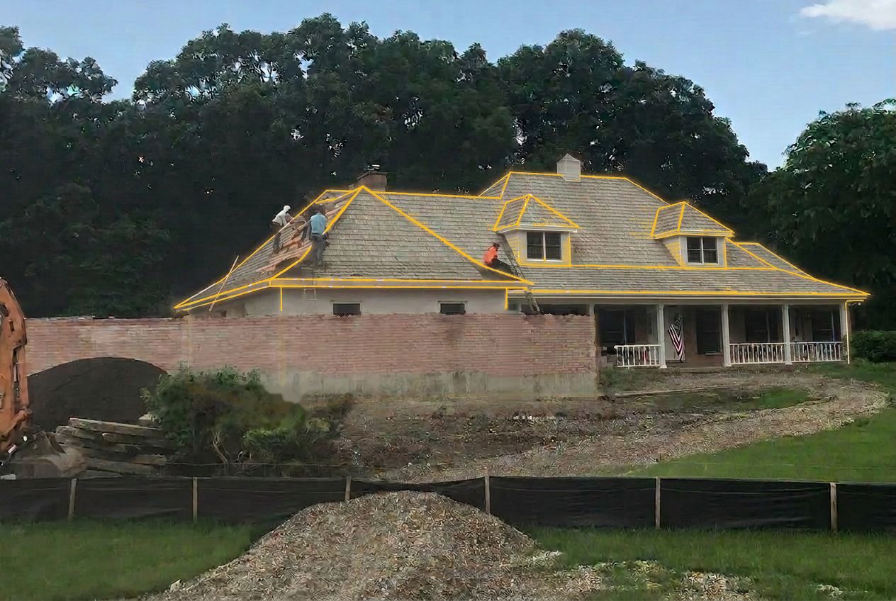 Same home under construction with workers on the open roof deck and a light architectural framing sketch drawn over the house